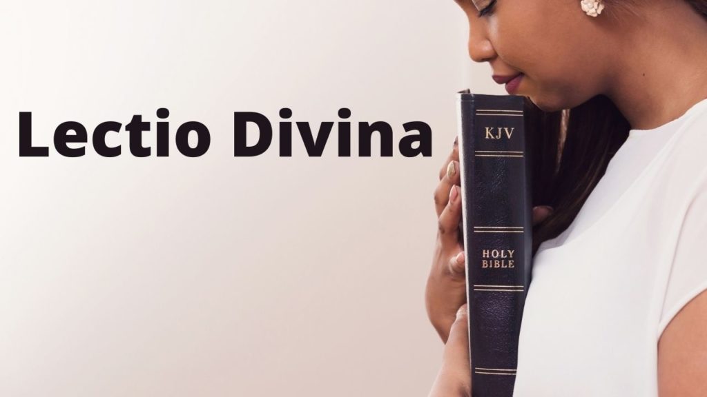 Woman holds a bible with eyes closed