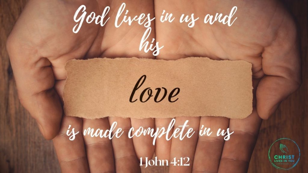 Two cupped hands hold a sheet of paper with the word "love" written on it