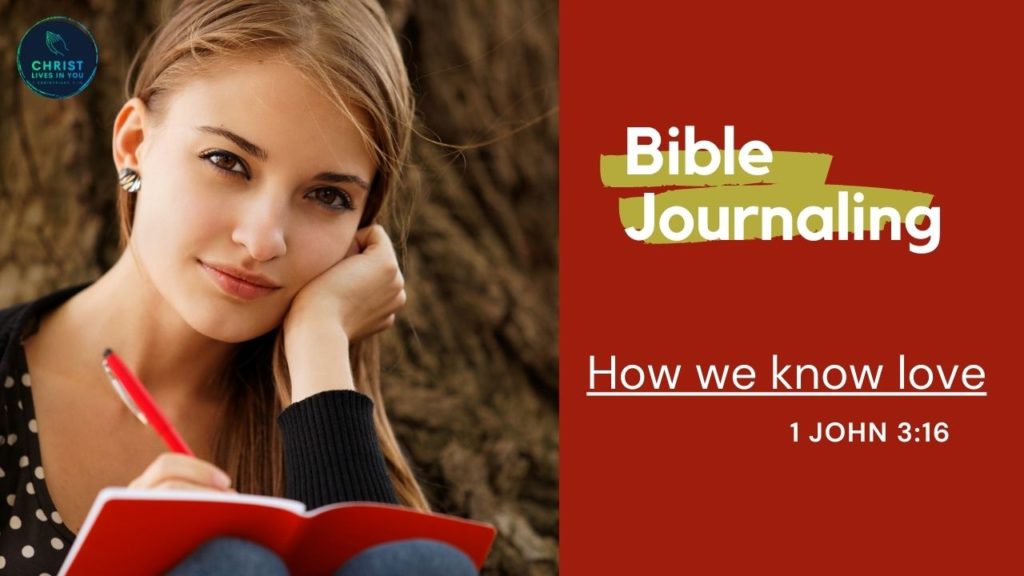 A woman sits and journals against a tree