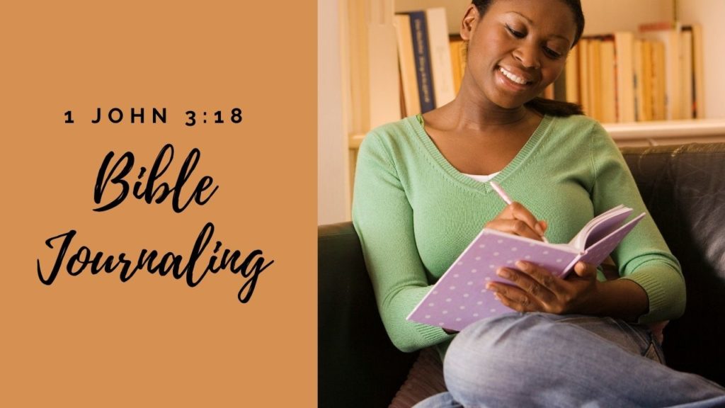 A woman smiles as she sits and journals