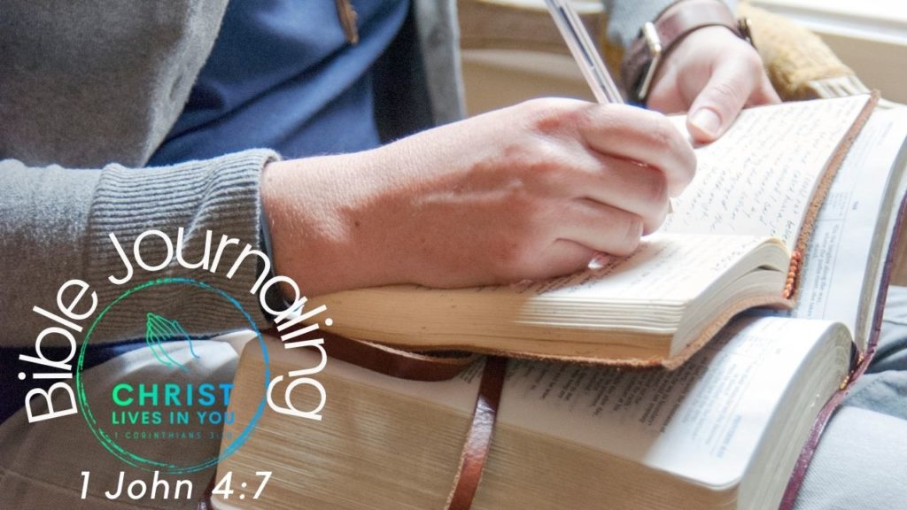 A man sits and journals with a Bible on his lap.
