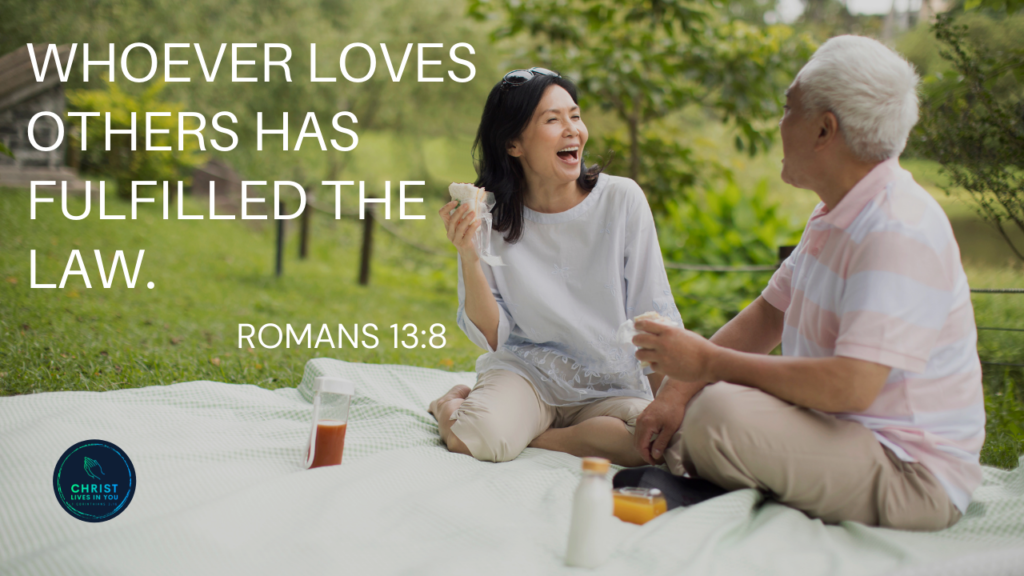 Two friends sit and enjoy each others company at a picnic and clearly care and love one another