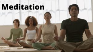 People sit to meditate with their eyes closed