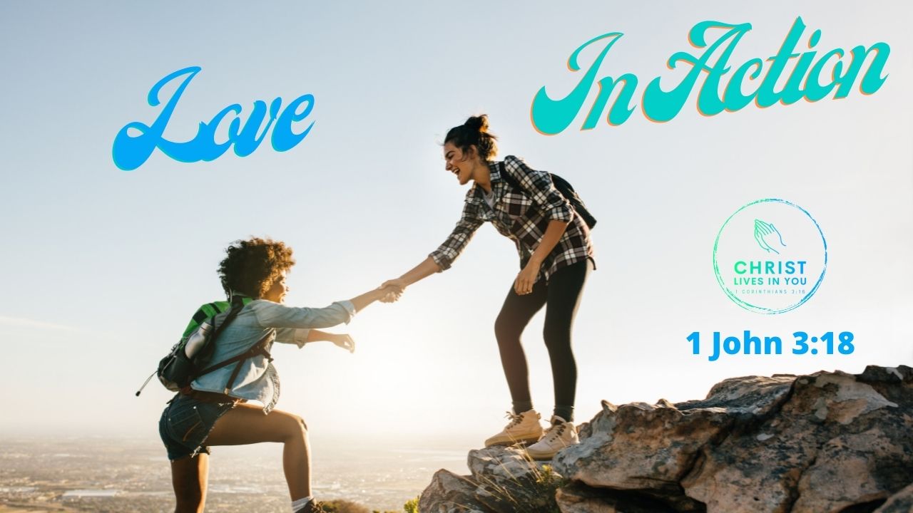 Two friends help each other up a mountain